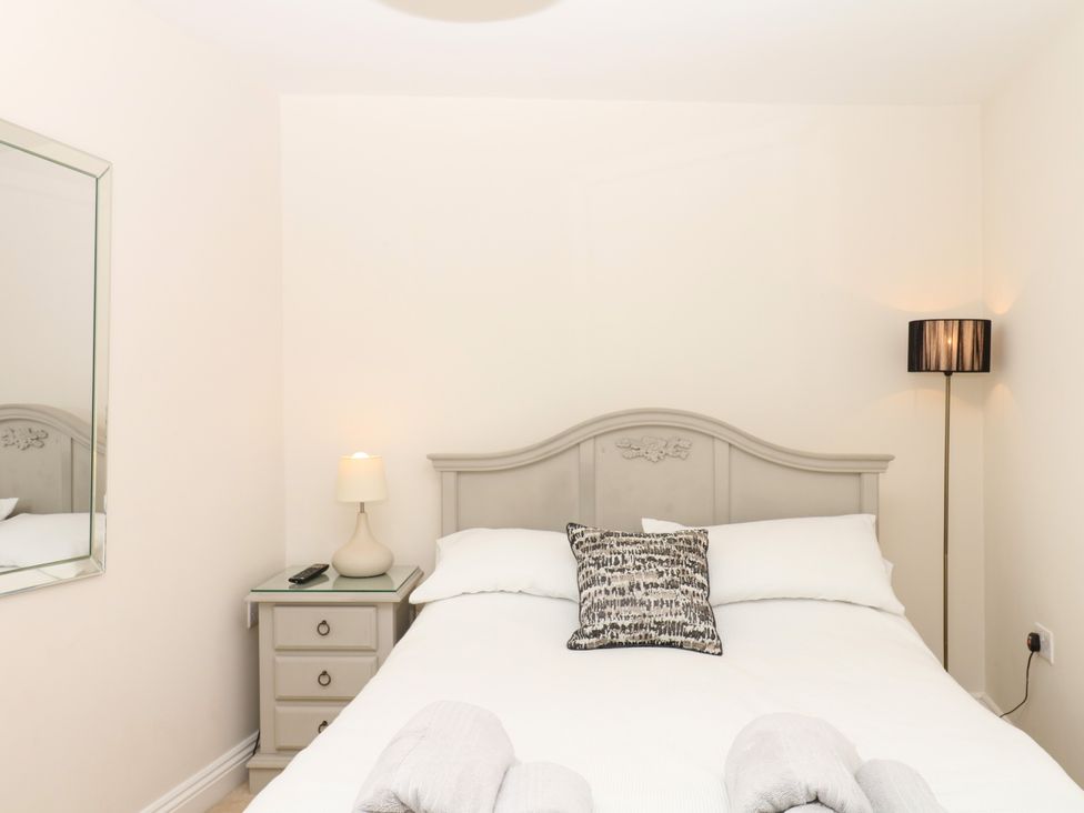 A bedroom with a bed and bedside table at Dennings House, Mayors Avenue, Dartmouth
