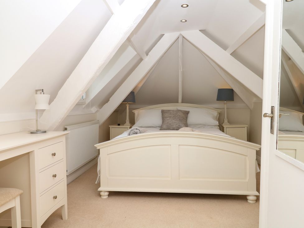 A bedroom with a bed and dresser at Dennings House, Mayors Avenue Dartmouth