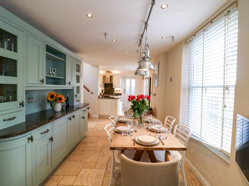 A kitchen with a dining table and chairs at Dennings House, Mayors Avenue, Dartmouth