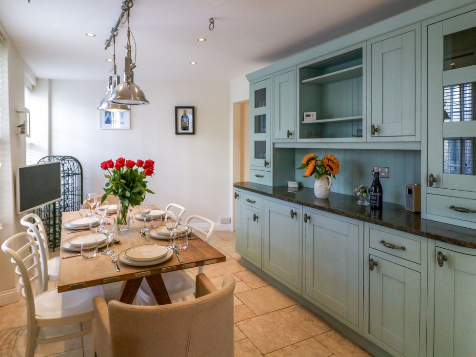 A dining room with a table and chairs at Dennings House, Mayors Avenue in Dartmouth