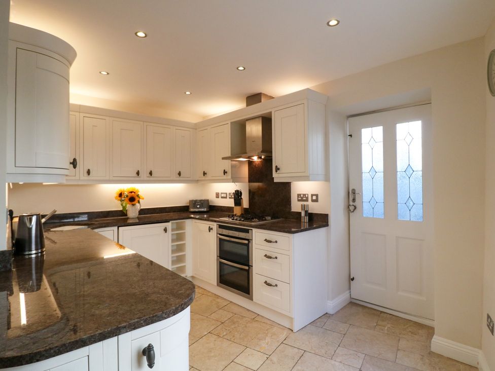 A kitchen with cabinets and appliances at Dennings House, Mayors Avenue in Dartmouth