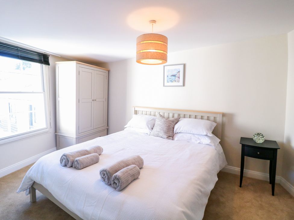 A bedroom with a bed and a wardrobe at Dennings House, Mayors Avenue, Dartmouth
