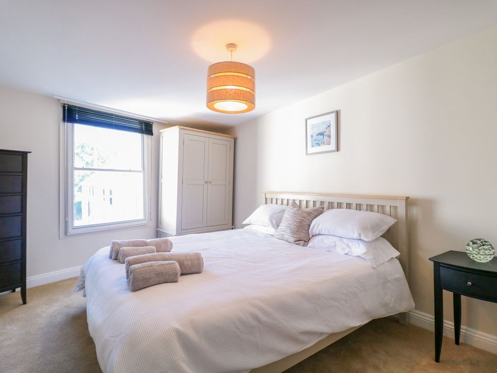 A bedroom with a bed and a wardrobe at Dennings House, Mayors Avenue, Dartmouth