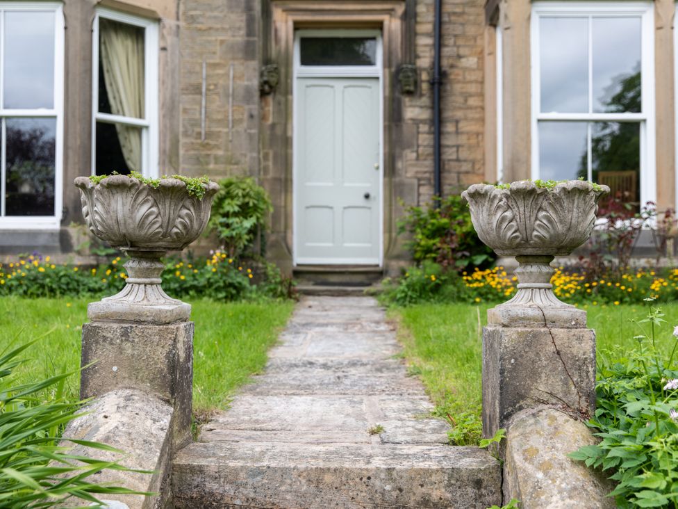An entrance with planters and a pathway at The Clarence in Bishop Auckland