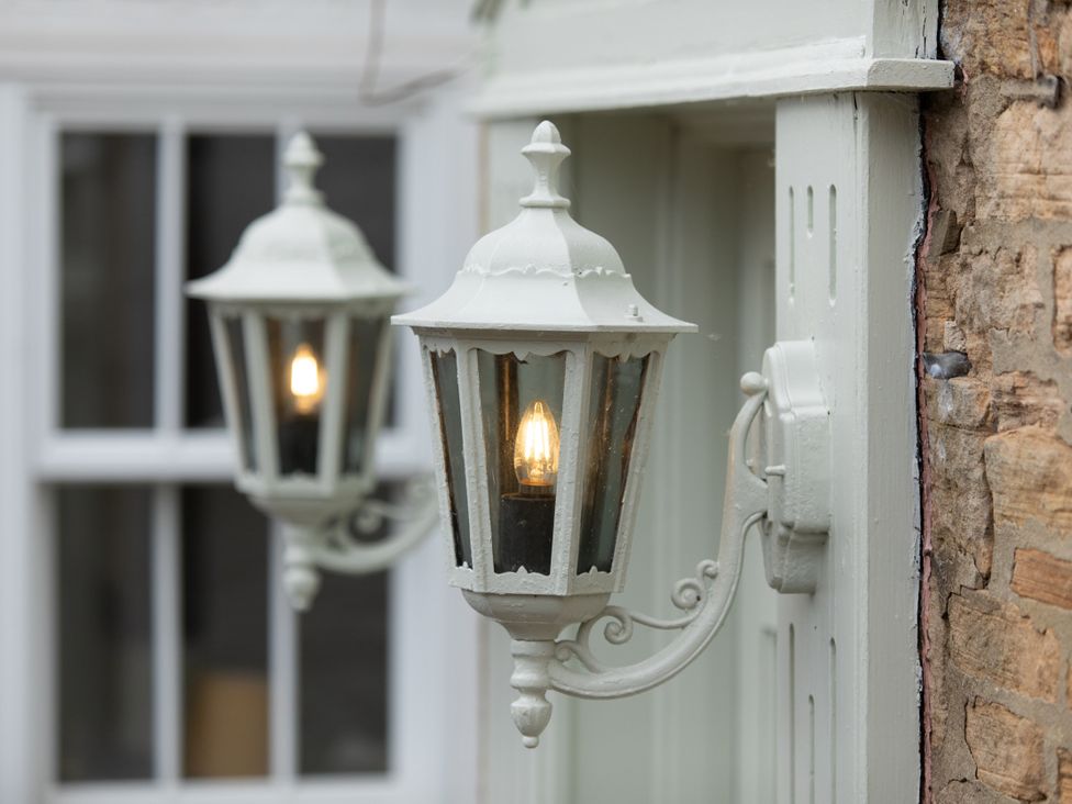 Outdoor wall lamps beside a window at The Clarence in Bishop Auckland