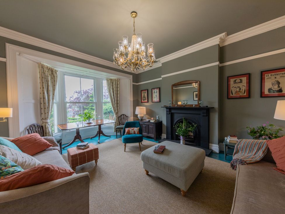 A living room with a fireplace and seating area at The Clarence in Bishop Auckland