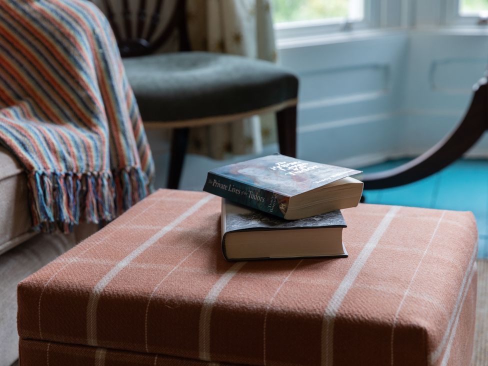 A living room with books on an ottoman at The Clarence in Bishop Auckland