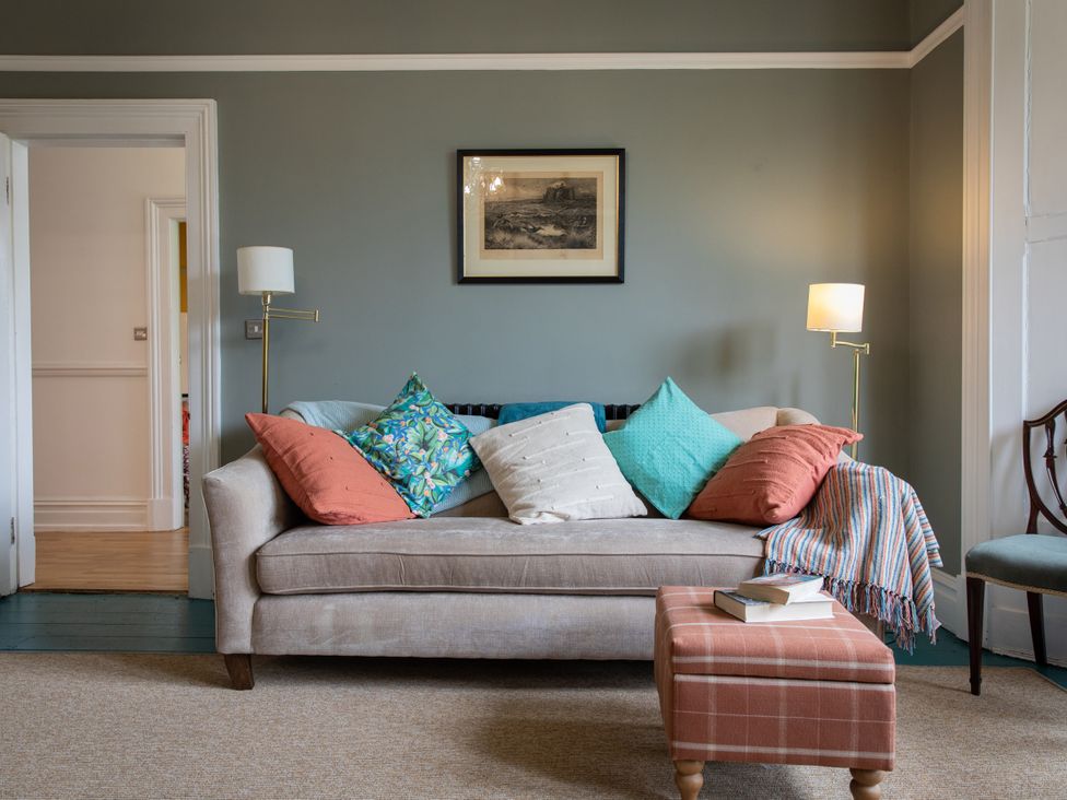 A living room with a sofa and cushions at The Clarence Bishop Auckland