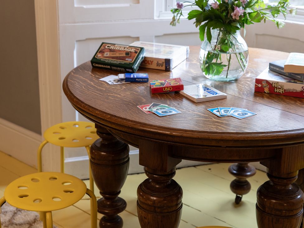 A living room with a table and board games at The Clarence in Bishop Auckland
