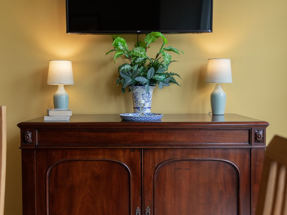 A living room with a television and lamps on a table at The Clarence in Bishop Auckland
