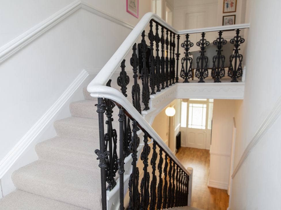 A staircase with a black railing at The Clarence in Bishop Auckland