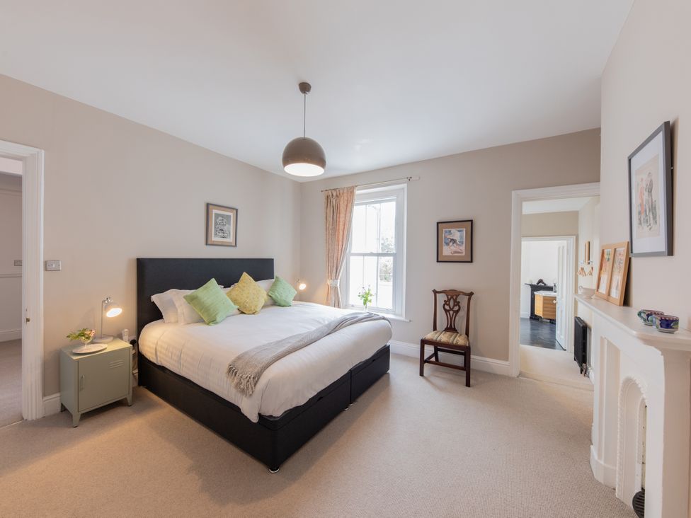 A bedroom with a bed and nightstand at The Clarence in Bishop Auckland
