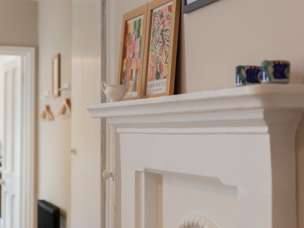 A living room with artworks on a fireplace at The Clarence in Bishop Auckland