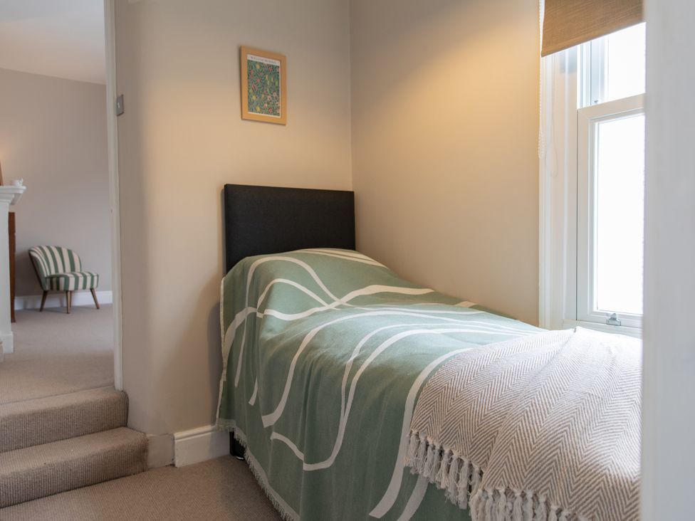 A bedroom with a bed and window at The Clarence in Bishop Auckland