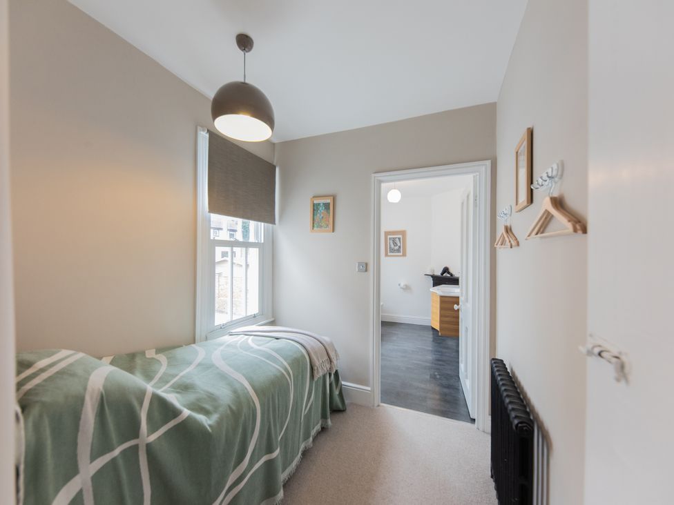 A bedroom with a bed and window at The Clarence in Bishop Auckland