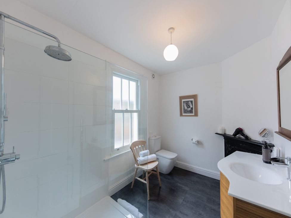 A bathroom with a shower, toilet, and sink at The Clarence in Bishop Auckland