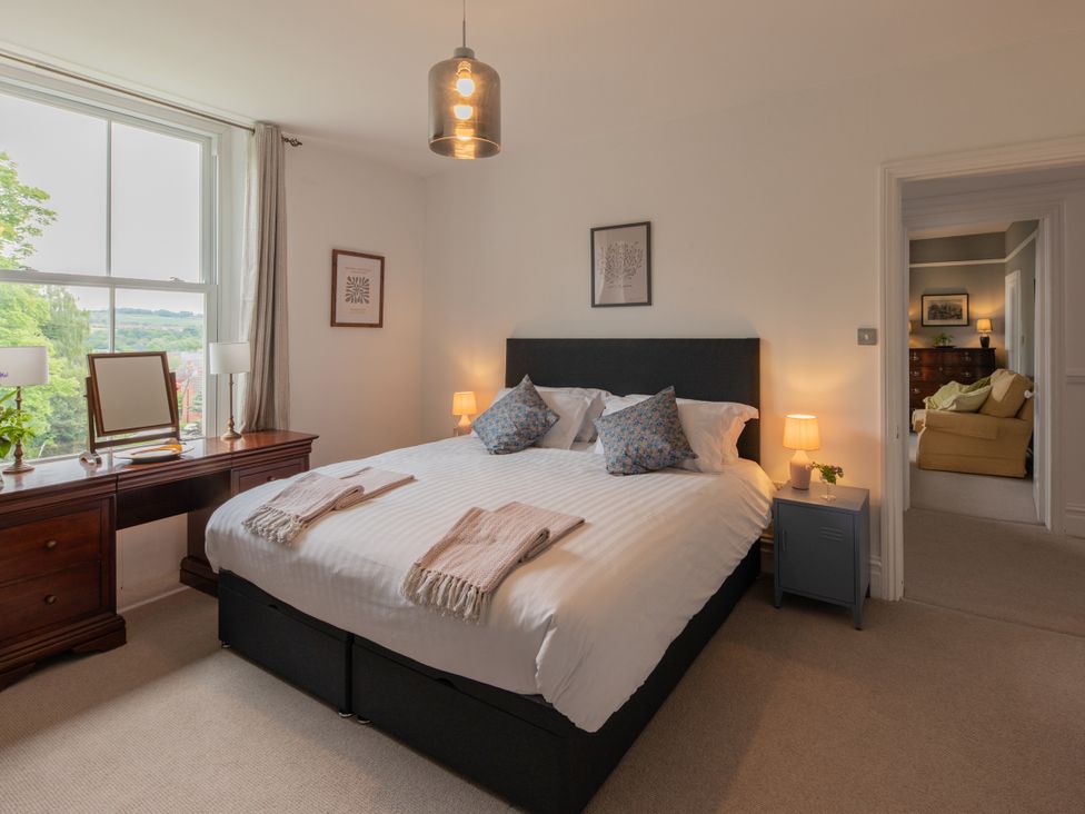 A bedroom with a bed and desk at The Clarence in Bishop Auckland