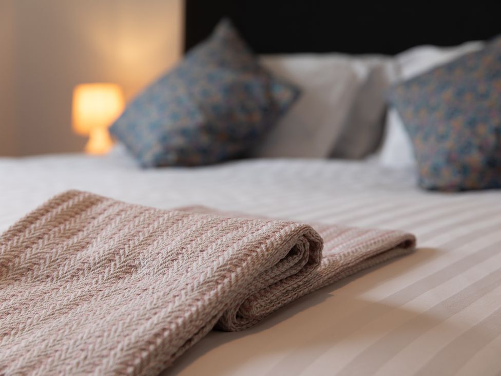 A bedroom with a folded blanket and pillows at The Clarence in Bishop Auckland