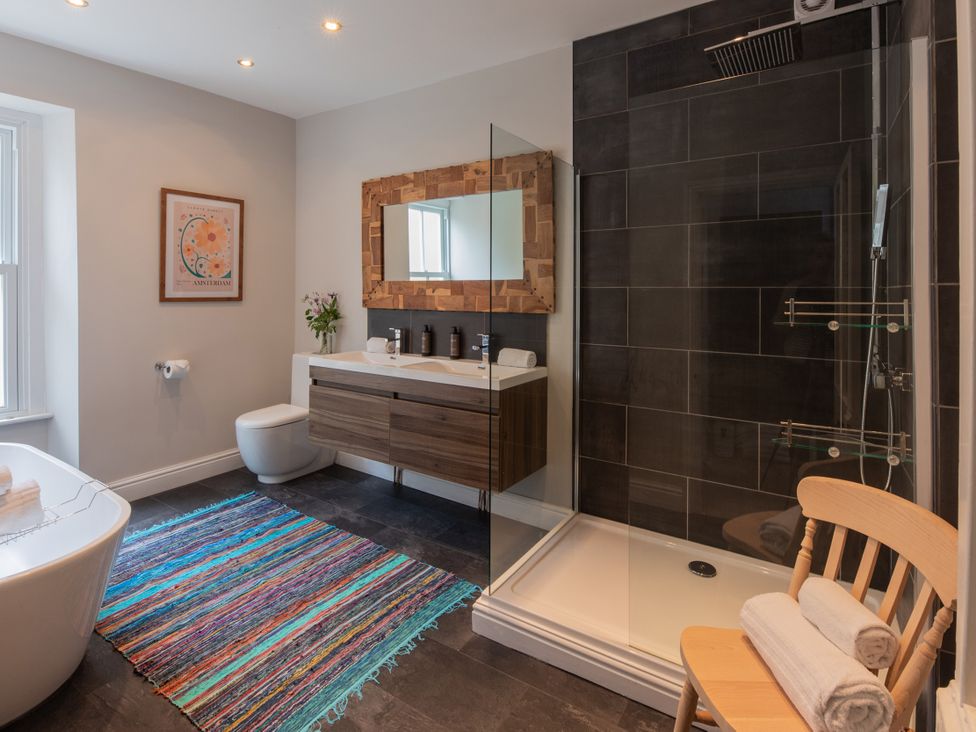 A bathroom with a shower and bathtub at The Clarence in Bishop Auckland