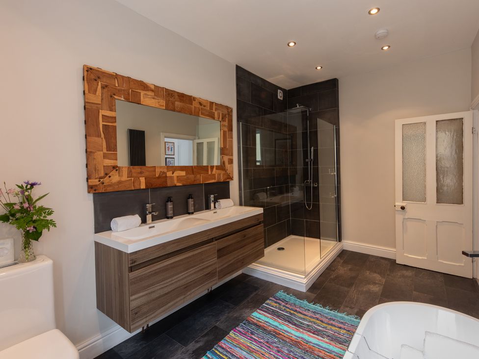A bathroom with a shower, sink, and toilet at The Clarence in Bishop Auckland