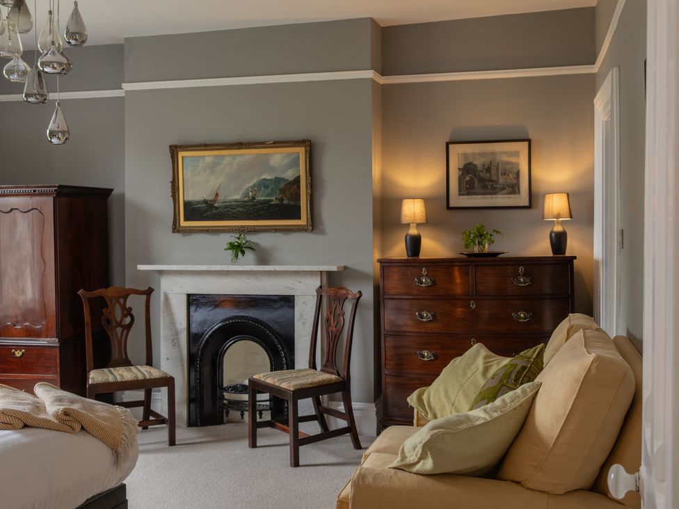 A sitting room with a fireplace and furniture at The Clarence in Bishop Auckland