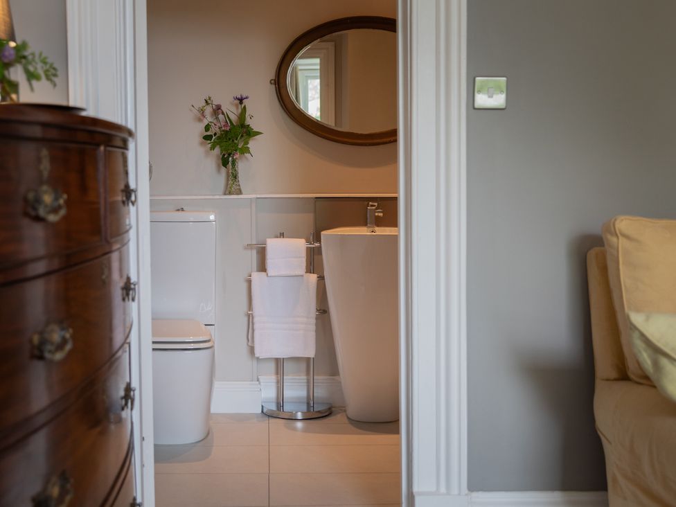 A bathroom with a toilet and a bathtub at The Clarence in Bishop Auckland