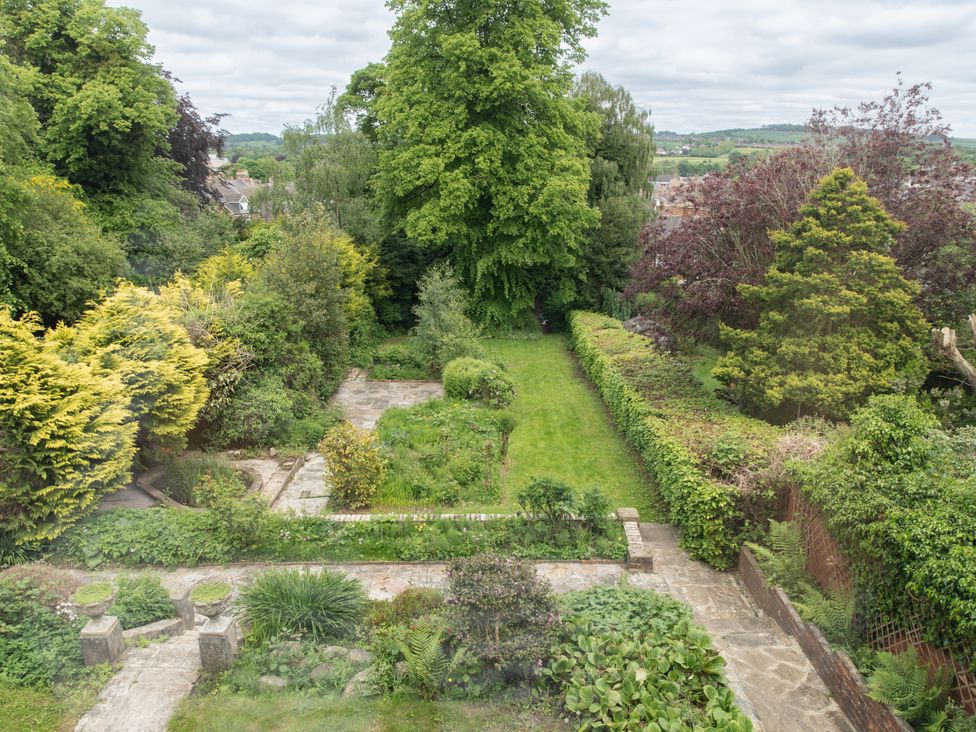 A garden with grass and shrubs at The Clarence in Bishop Auckland