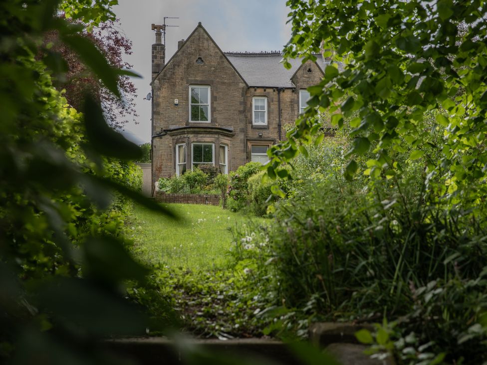 A house with a garden viewed through plants at The Clarence in Bishop Auckland