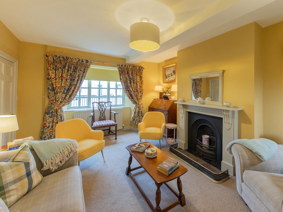 A living room with sofa and fireplace at Churchill Cottage in Bishop Auckland