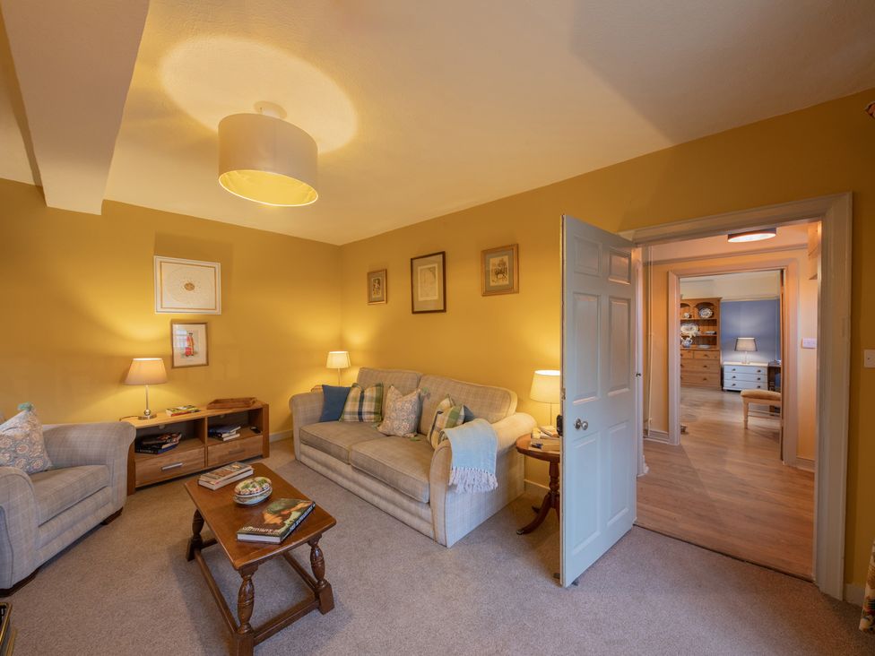 A living room with a sofa and coffee table at Churchill Cottage in Bishop Auckland