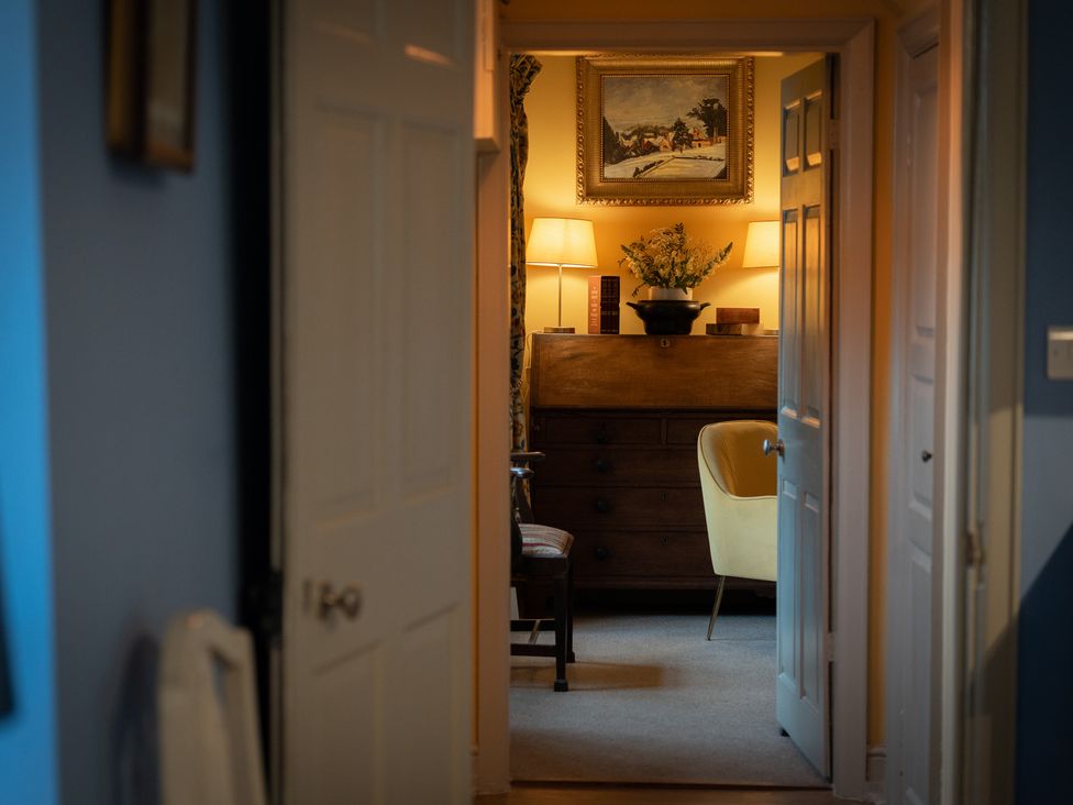 A living room with a chest of drawers and lamp at Churchill Cottage in Bishop Auckland