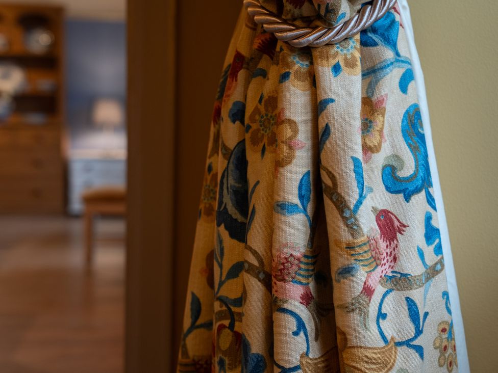 A curtain with a rope tieback at Churchill Cottage in Bishop Auckland