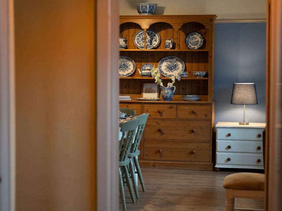 A dining room with a wooden table and chairs at Churchill Cottage in Bishop Auckland