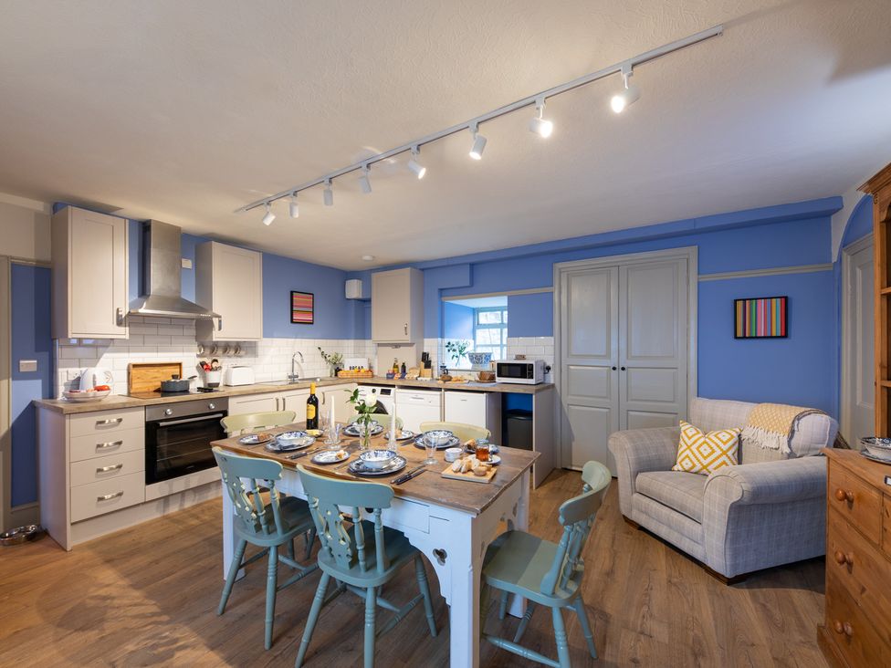 A kitchen with a table and chairs at Churchill Cottage in Bishop Auckland