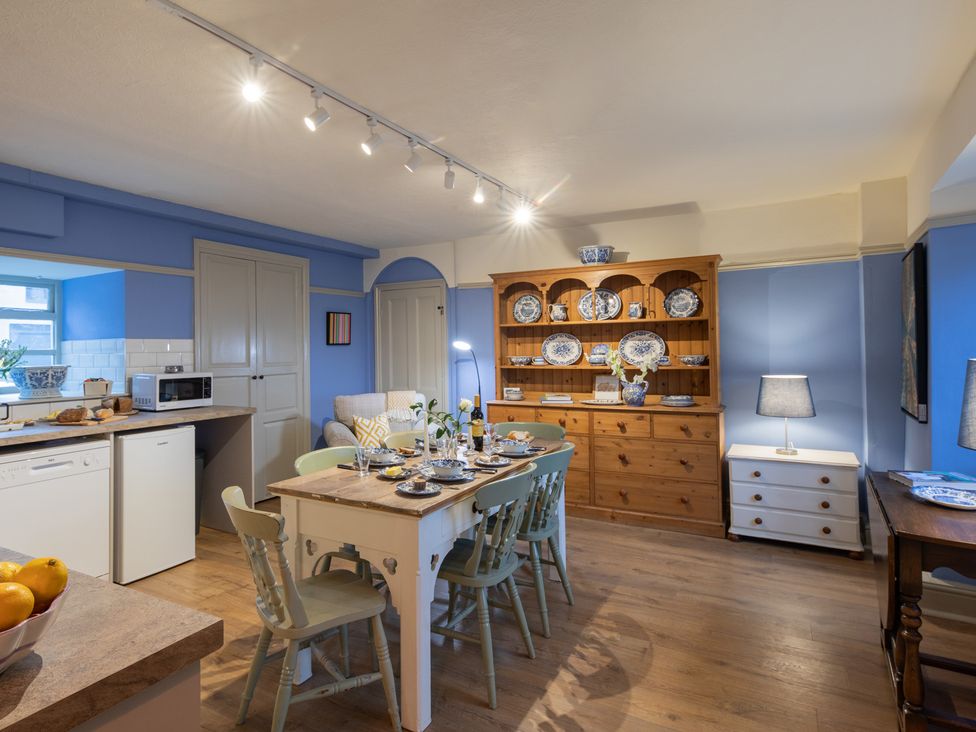 A kitchen with dining table and chairs at Churchill Cottage in Bishop Auckland
