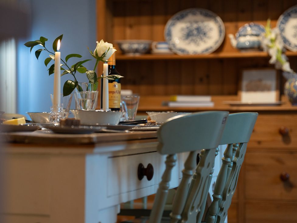 A dining room with a table set for a meal at Churchill Cottage in Bishop Auckland