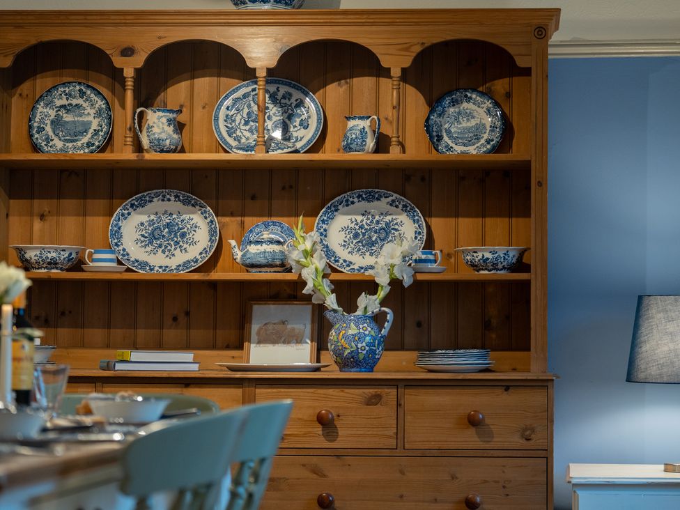 A display cabinet with blue and white dinnerware in the dining room at Churchill Cottage Bishop Auckland