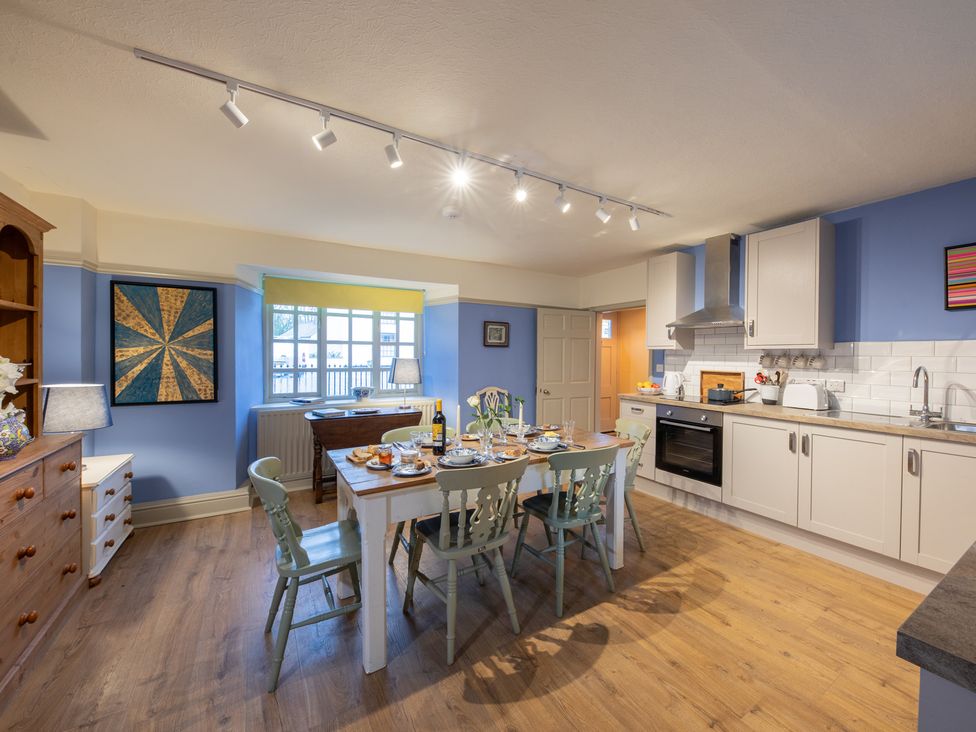 A kitchen with a dining table and chairs at Churchill Cottage in Bishop Auckland