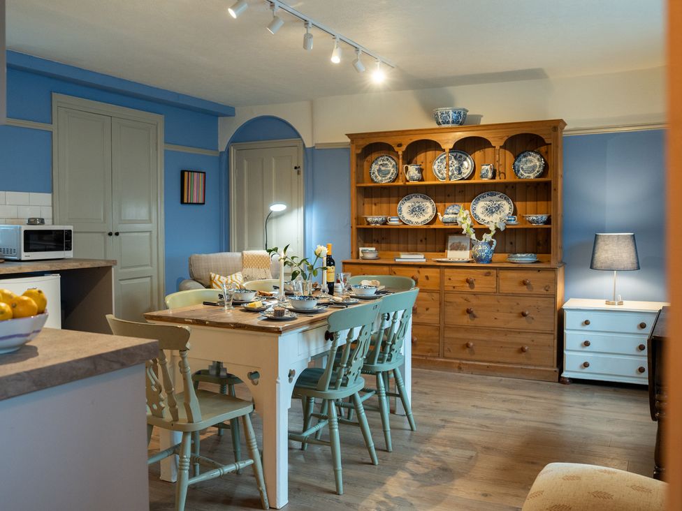 A kitchen with a table and chairs at Churchill Cottage in Bishop Auckland