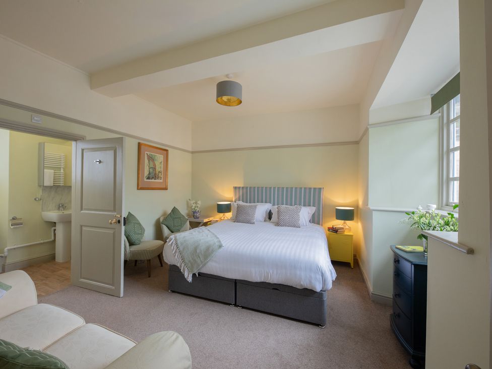 A bedroom with bed and nightstand at Churchill Cottage in Bishop Auckland