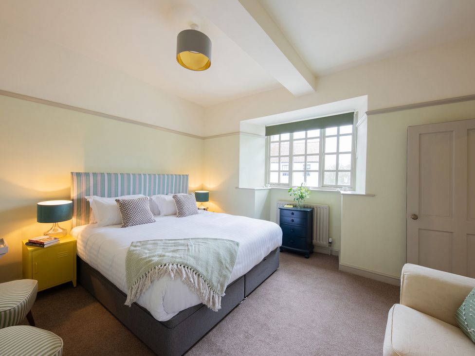 A bedroom with a bed and furniture at Churchill Cottage in Bishop Auckland