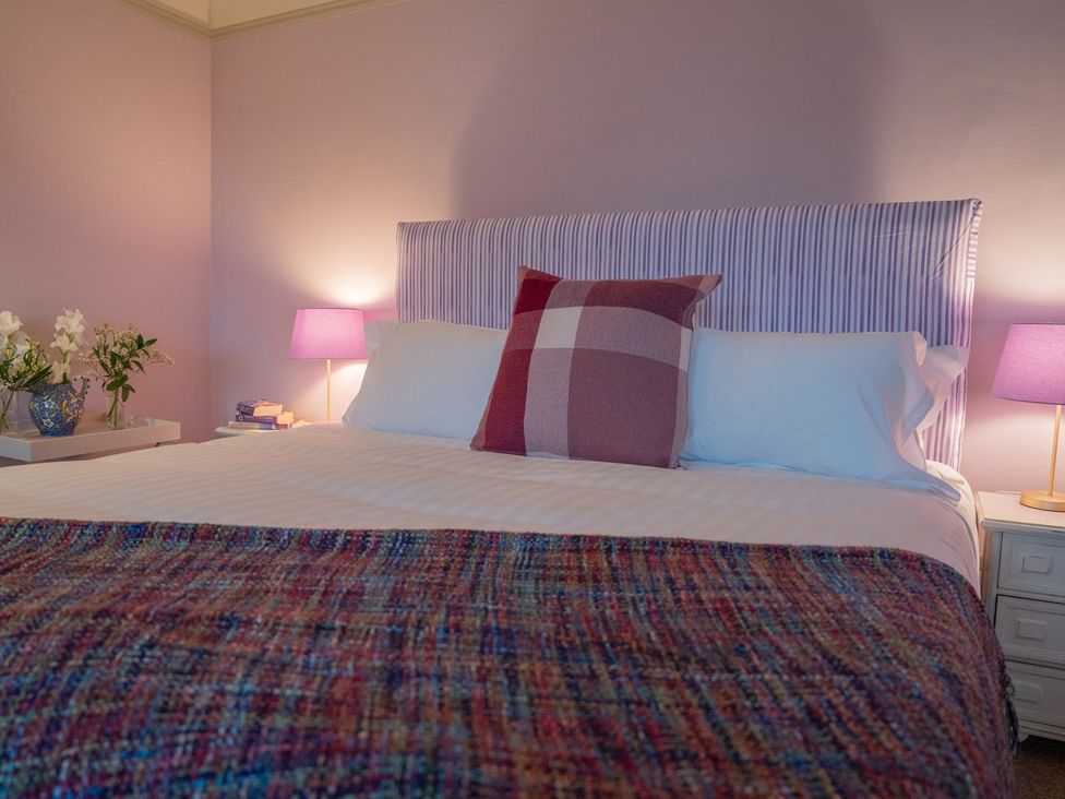 A bedroom with a bed and bedside table at Churchill Cottage in Bishop Auckland