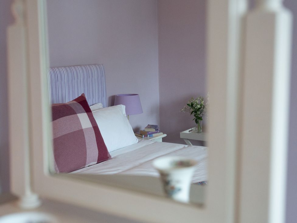 A bedroom with a bed and bedside table at Churchill Cottage in Bishop Auckland