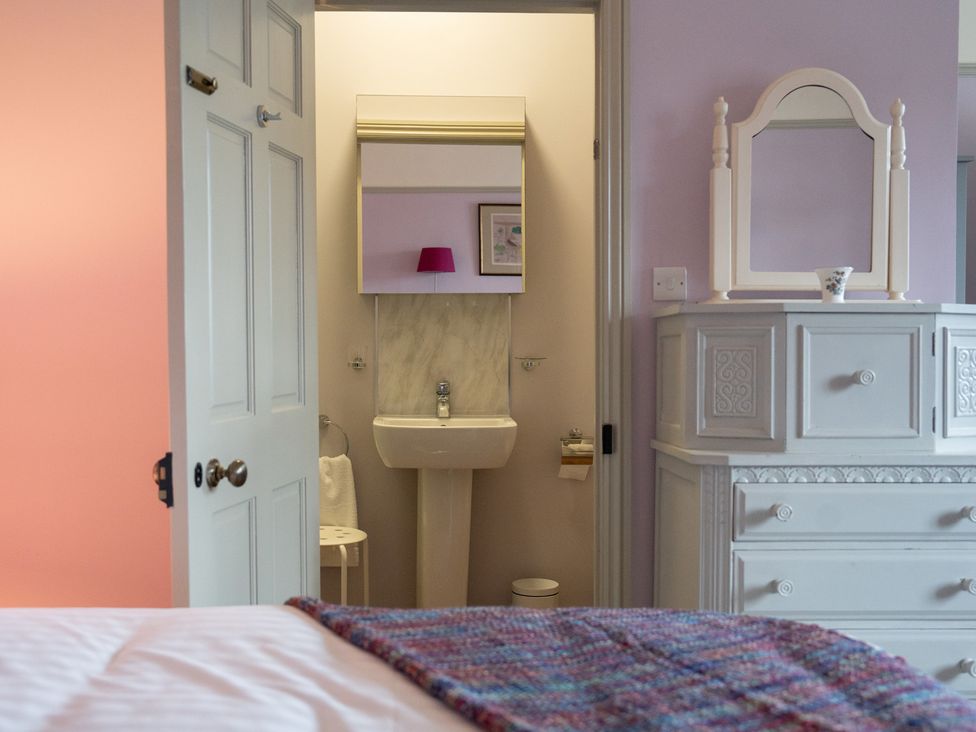 A bedroom with a view of the bathroom at Churchill Cottage in Bishop Auckland