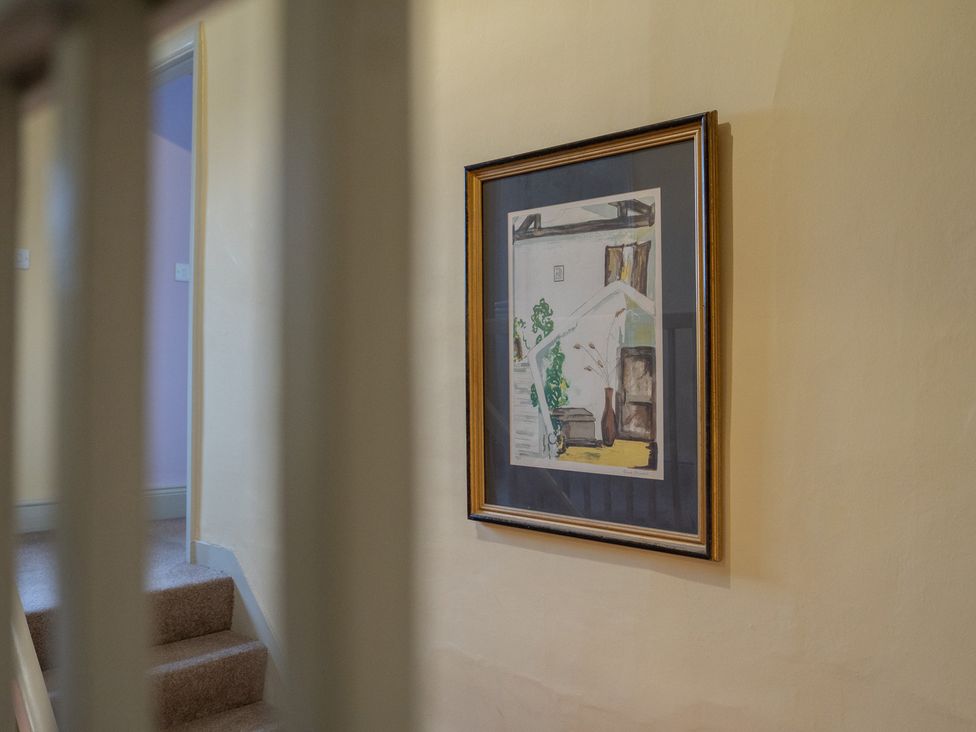 A framed painting on the wall in a hallway at Churchill Cottage in Bishop Auckland