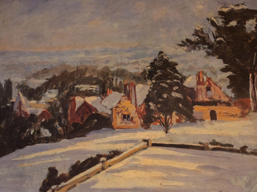 A winter scene with snow-covered houses and trees at Churchill Cottage in Bishop Auckland