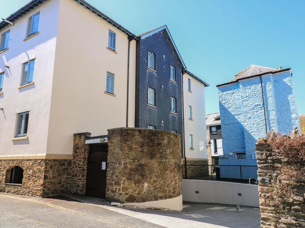 A view of multiple buildings and a stone wall at 6 Dartmouth House in Dartmouth