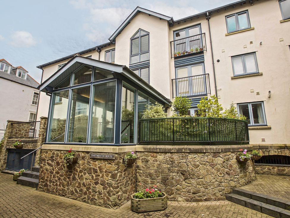 A glass extension with a garden area and stone wall at 6 Dartmouth House, Dartmouth