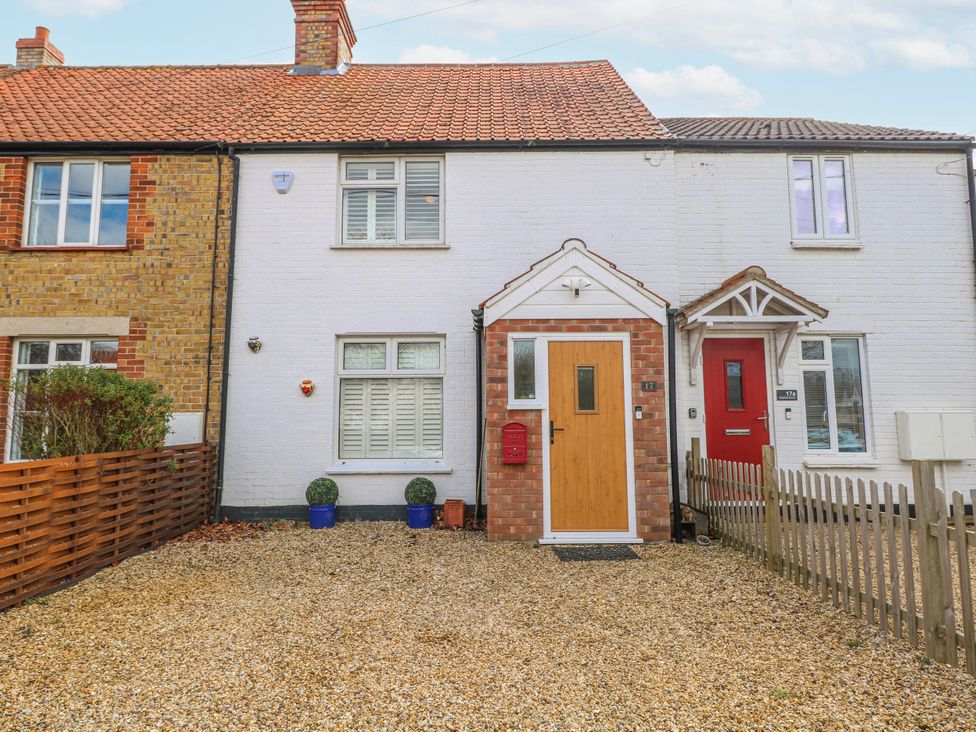 A house with a gravel driveway and a front door at 17 Woodside Avenue in King's Lynn