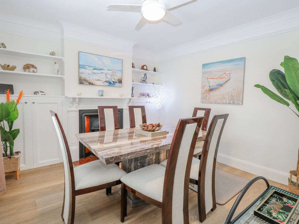 A dining room with a table and chairs at 17 Woodside Avenue in King's Lynn